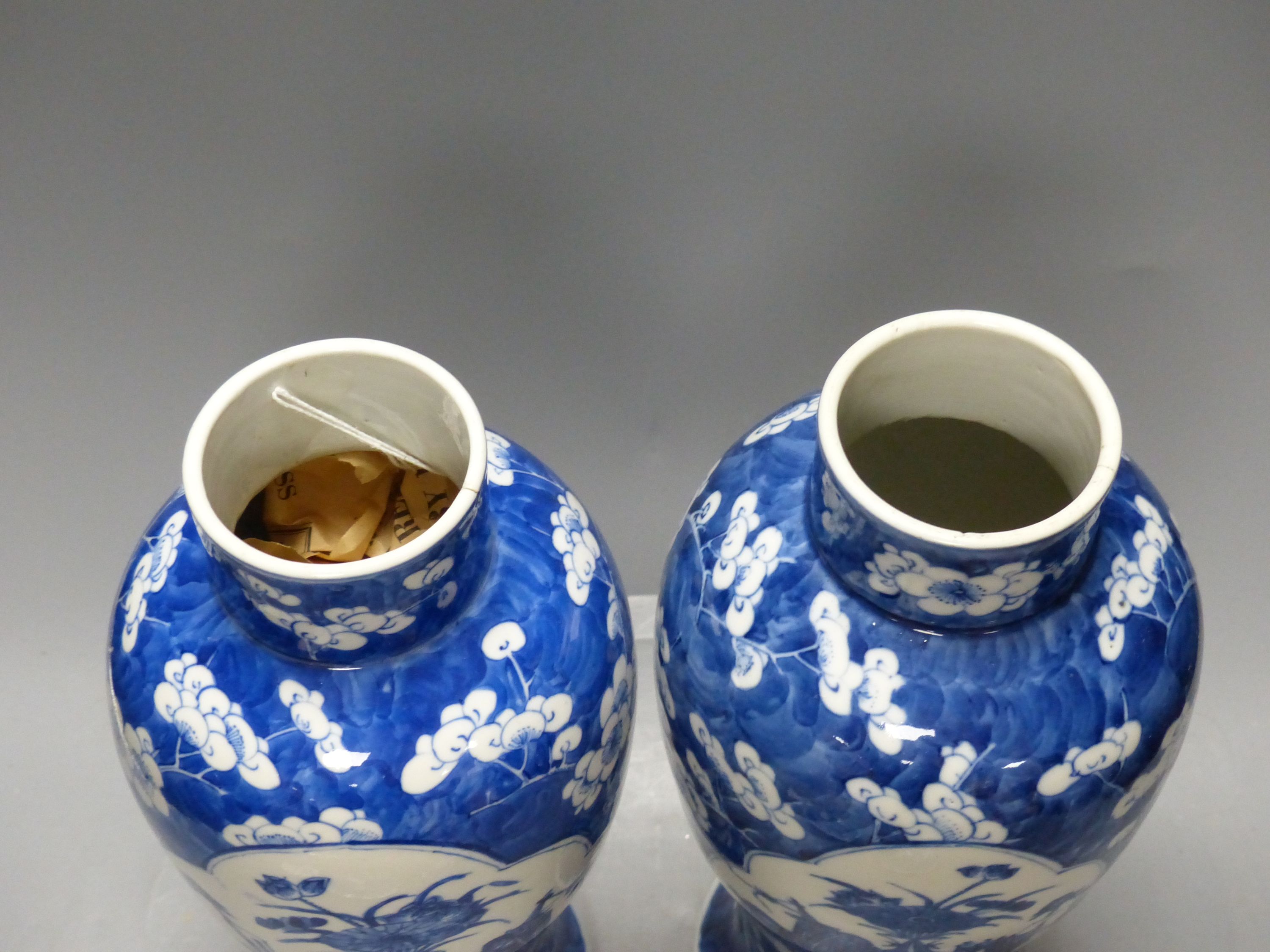 A pair of 19th century Chinese blue and white prunus vases and covers, height 38cm, a Kangxi marks